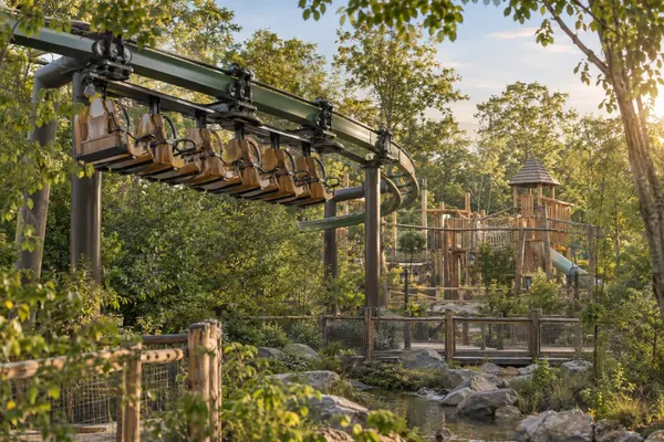AI-generated editorial concept of a suspended family coaster and woodland play area.