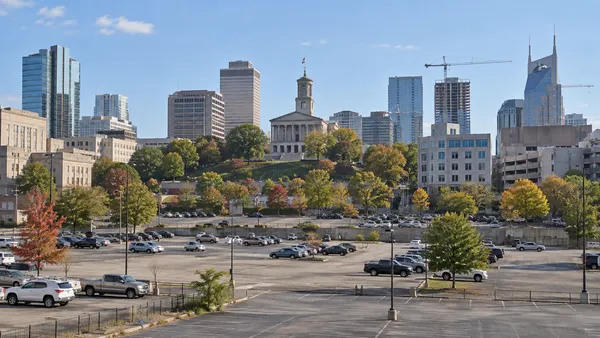 Surface parking lots and surrounding buildings in a generic downtown Nashville Capitol-area setting.