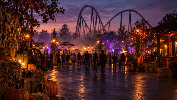 A generic Texas theme-park midway at dusk with a roller-coaster silhouette, autumn decorations and subtle fog.