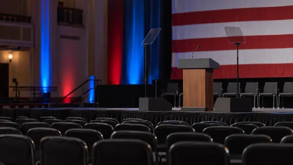Empty American political campaign stage with lectern and teleprompters