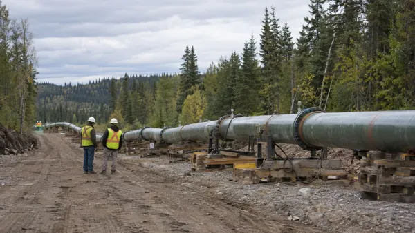 Illustration of a temporary pipeline bypass under inspection in a forested work corridor.