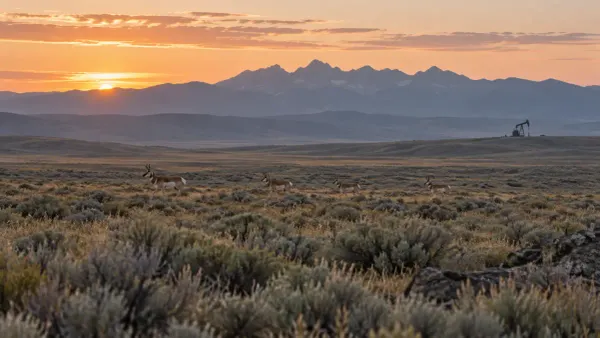 Illustrative Wyoming migration corridor with distant pronghorn and energy equipment