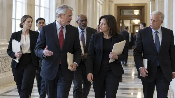 Bipartisan U.S. senators leaving a Capitol committee room after an energy policy briefing