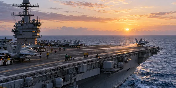 A generic aircraft carrier conducts early-morning flight operations at sea.