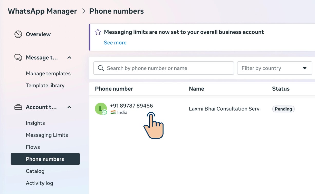 WhatsApp Manager Phone numbers list showing a phone number entry with a click cursor indicating to select it