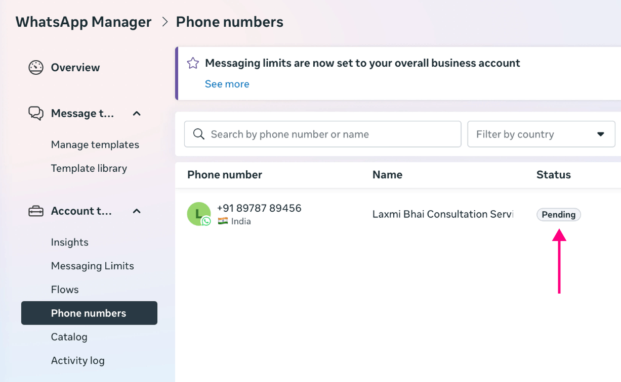 WhatsApp Manager "Phone numbers" screen showing the number with a "Pending" status highlighted by a pink arrow.