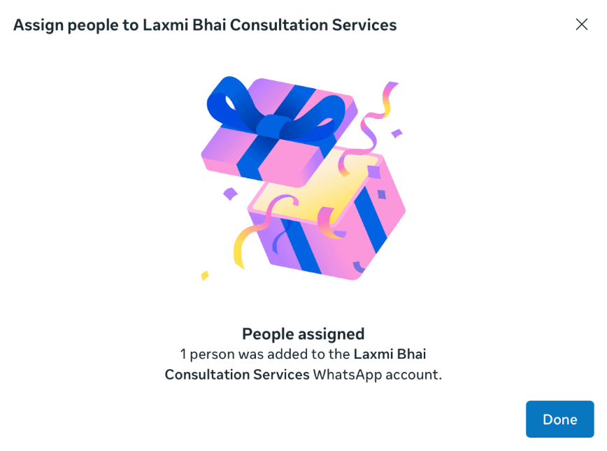 Success dialog confirming "People assigned β 1 person was added to the Laxmi Bhai Consultation Services WhatsApp account."