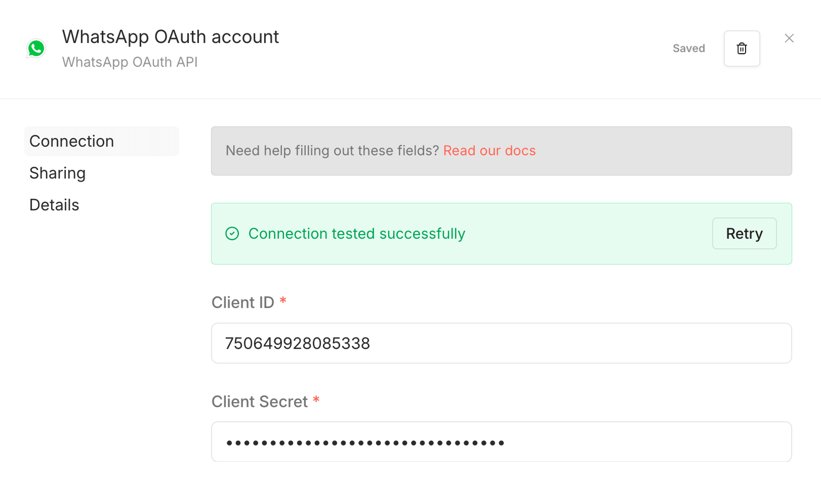 WhatsApp OAuth account settings panel showing a green "Connection tested successfully" banner, with Client ID and Client Secret fields filled in and a "Saved" status in the top corner.