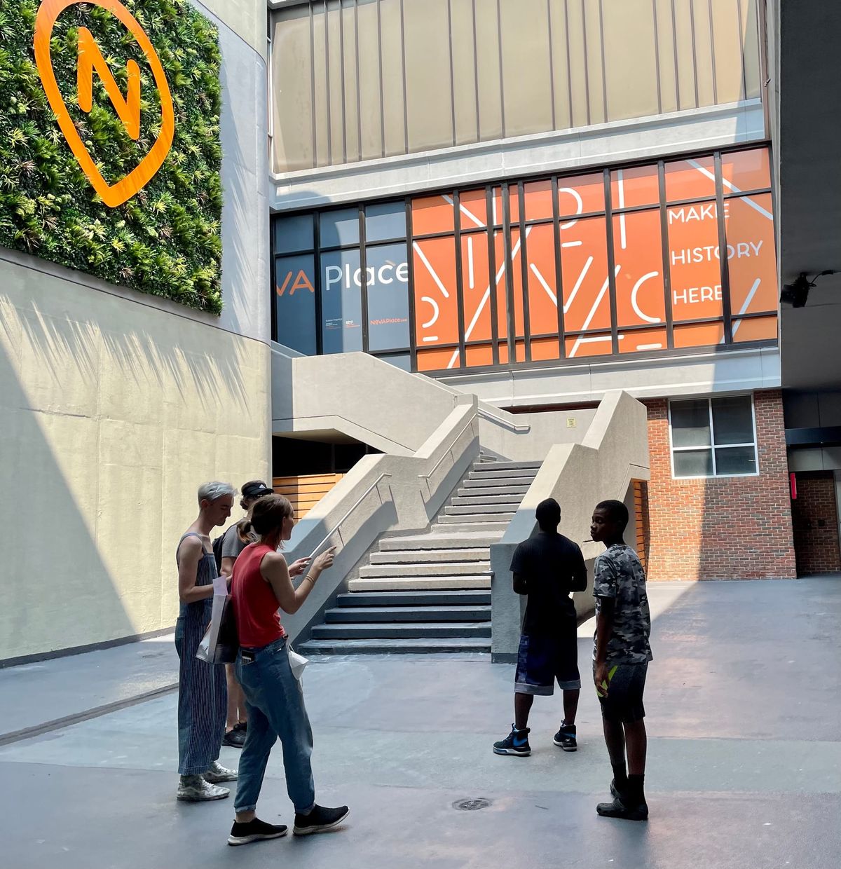 Five people stare at security cameras, necks craned. 