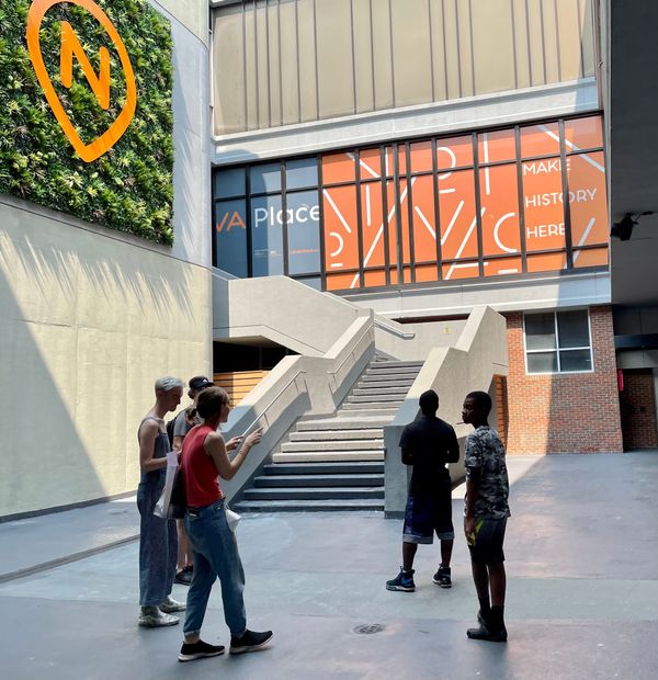 Five people stare at security cameras, necks craned. 