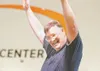 ROBERT DeBERRY/Frontiersman Trim To Win community weight loss
challenge winner John Brown raises his arms in victory at being
announced the winner of the contest Monday evening at the AT&amp;
