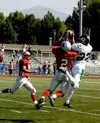 Colony wide out Justin Schwartzbauer (right) leaps above an East
defensive back to make a catch during the first half of the
contest. Photo by JEREMIAH BARTZ/Frontiersman