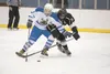 Palmer forward Christopher Dojka battles South’s Trevor Geerin for control of the puck during a Thursday quarterfinal game at the ninth annual Curtis C. Menard II Memorial Hockey Tournament i