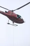 Soloy pilot Max Monasta maneuvers the helicopter over the bags of gravel. STEVEN MERRITT/Frontiersman