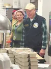 Mat-Su Borough Assemblyman Noel Woods helps prepare food for the Meals on Wheels program March 21. Dignitaries, including Woods and Palmer Mayor DeLena Johnson, helped out as part of the annu