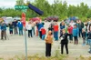 Cheryl Riggs pulls the cover to reveal a road sign for ‘John Riggs Road Memorial’ during a ceremony naming the road in her husband’s honor July 9. Courtesy Patty Sullivan
