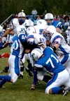 Palmer linebacker J.C. Forrester and lineman Junior Aumavae
tackle North Pole running back Perry Monzulla during the first
quarter of Palmer's 18-15 win over the Patriots on Friday. Photo by
