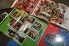 A collection of yearbooks from 2005, seen on Wednesday, show images of the graduating classes at Anchorage’s high schools. Shown are yearbook pages from West Anchorage High School, Dimond Hig