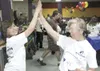 GREG JOHNSON/Frontiersman Adrianna Nyburg, 10, and her Big
Sister, Lori Bennett, share one of many high-fives at the annual
Bowl For Kids’ Sake event, a fund-raiser for Big Brothers Big
Siste