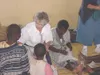 Photos courtesy of Jean Straatmeyer Jean Straatmeyer, center,
shows Malawi orphans how to sew in 2001. Straatmeyer travelled to
the famine-stricken country to be of service to her church. The