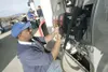 ROBERT DeBERRY/Frontiersman Lucky Dawkins applies octane
stickers to the pumps at the new Fred Meyer gas station in Palmer
Monday afternoon. A representative of Pinnacle Construction said
thi