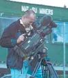 An HBO cameraman sets up his gear on top of the Mat-Su Miners
dugout at Hermon Brothers Field on Thursday. A production team from
HBO Sports was at the Palmer ballpark to shoot footage for a
