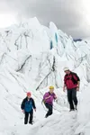 TOM BOL/Mat-Su CVB An ice trekking guide leads a couple across
Matanuska Glacier. Self-guided tours are available as well, with
access at Glacier Park on the Glenn Highway National Scenic
Byw