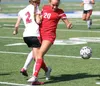 Wasilla's Lydia Phillips collides with Kenai's Samantha Morse during a 2-1 overtime loss to the Kardinals in the Northern Lights Conference semifinals May 22 at Palmer High School. JEREMIAH B