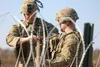Spc. Edwin Miranda and Sgt. Kyle Moitoza of Bravo Company, 1st Brigade Engineer Battalion, 1st Armored Brigade Combat Team, 1st Infantry Division, prepares a Bangalore explosive for the wired