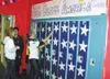 Top left, Whitney Kinsey, left, watches Audrey Smith tape a
locker in the Colony High School freshman hall. Colony freshmen
decorated their hall in a patriotic theme for homecoming. CASEY
RES