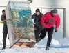 Jared, Wade and Keith Schachle pour on the speed and almost tip their outhouse as they round the second corner during the 2012 outhouse race at the Willow State Winter Carnival at the Willow 