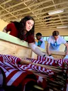 Destiney Campbell, Mountain Home Air Force Base and Idaho state youth of the year, stows flags at the Fort Sam Houston Cemetery, San Antonio. During their week in Texas, Campbell and about 60