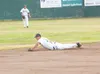 ROBERT DeBERRY/FrontiersmanMiner's Derek Helenihi hits the dirt
while attmpting to stop a ground ball Friday during the Miner's
final series game against the Peninsula Oilers.