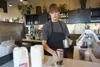 Stryder Greenhalgh, 17, serves a latte he made on Oct. 9, 2025. Greenhalgh works at Black Cup, a coffee shop in Midtown Anchorage. The population of Alaskans of prime working age has diminish