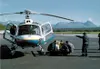 A team of emergency responders, with directions from Margie
Bauman, practices loading a patient onto a stabilizer board, then
into the helicopter. Photo courtesy Mat-Su Borough.