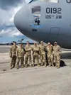 U.S. Airmen, crew members of Reach 824, 105th Airlift Wing, New York National Guard, pose for a photo in front of a C-17 Globemaster III at Joint Base Charleston in North Charleston, South Ca