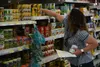 Susanna Wilkerson selects groceries as a volunteer shopper for the USAG Stuttgart concierge shopper program. (Becca Castellano, USAG Stuttgart)