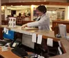 Alaska State Fair vender Sandy Shader checks in at the Valley Hotel Front Desk Wednesday afternoon. The Valley Hotel and the Colony Inn both see an uptick in reservations for almost two weeks