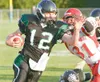 ROBERT DeBERRY/Frontiersman Colony Knight Colin Murphy breaks
past an East High Thunderbird tackle during the first period of
Saturday's game at Colony High School.