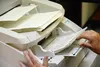 Laraine Derr feeds ballots through a scanner on Wednesday, June 15, 2022 at the Division 1 office of the Alaska Division of Elections in Juneau, Alaska. Derr was among elections workers count