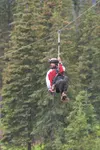 A Glacier View Adventures client tries the Nitro Zipline Wednesday afternoon. The rock in his hand is for a game where he will try to drop it into a hula hoop on the ground. This is the first