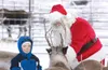 ROBERT DeBERRY/Frontiersman Santa Claus introduces Valley
resident Collin Creegan, 5, to one of his many reindeer at the
Alaska Reindeer Farm in the Butte.