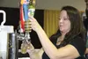Michelle Meacham pours a sample of Denali Brewing Company's Twister Creek IPA during the 2014 Matanuska Brewfest. This year’s event is Oct. 28 at Raven Hall on the Alaska State Fairgrounds. F