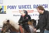 Ezra Gately rides a pony with his father, Christopher Gately, close by during the 2015 Colony Christmas festivities in downtown Palmer. Frontiersman file photo