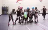 MeKenna Bills, center, tries to keep the pink-helmeted "jammers" from breaking through her team's line at junior roller derby practice in the Palmer borough gym. Caitlin Skvorc