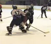 A Houston skater attempts to slip through with the puck in front
of the Palmer goal in the first period, but is cut off by Palmer
defenders who squeezed the Hawk away from the puck. Photo by 