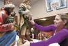 Janet Dinwiddie places the large nativity figures on their
pedestal Thursday afternoon at the Church of Jesus Christ of
Latter-day Saints in Palmer in preparation for this weekend’s
Colony Ch