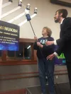 Janet Kincaid lights the first of five candles on the Menorah during the Hanukkah celebration hosted by the Mat-Su Jewish Center-Chabad at the Palmer Depot on Wednesday, Dec. 28. (Mary Lockma