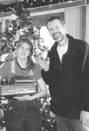 After bounding through the door, Larry Bottjen hugged Lizzie
Coon and handed her several presents. Bottjen had been Lizzie's
teacher at Iditarod Elementary. Submitted photo.