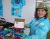 Jennifer Woods, owner of Alaska Puffin’ on the Go and Bushrat Boutique, shows a Smoking Adventure Box, featuring a hemp tie-dye ‘Adventure Flag.’ Jacob Mann/Frontiersman